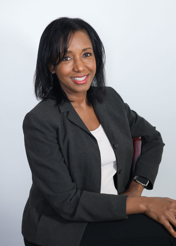 Dr. Anna-Maria Rivas McGowan seated in a studio portrait